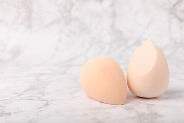 Beauty blender on marble background.Bright sponges for make-up cosmetics. Makeup products. Beauty concept. Place for text. Space for copy. Flat lay