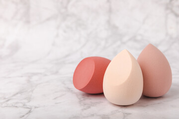 Beauty blender on marble background.Bright sponges for make-up cosmetics. Makeup products. Beauty concept. Place for text. Space for copy. Flat lay