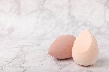 Beauty blender on marble background.Bright sponges for make-up cosmetics. Makeup products. Beauty concept. Place for text. Space for copy. Flat lay