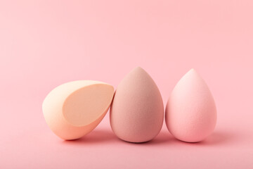 Beauty blender on a pink background.Bright sponges for make-up cosmetics. Makeup products. Beauty concept. Place for text. Space for copy. Flat lay