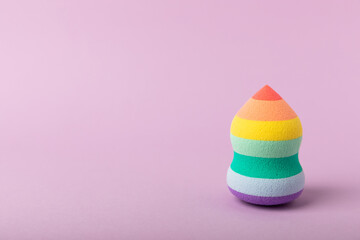 Beauty blender on lilac background.Bright sponges for make-up cosmetics. Makeup products. Beauty concept. Place for text. Space for copy. Flat lay
