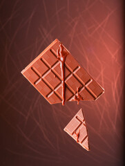 Flying chocolate bar with melted chocolate running down it. 