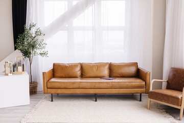 Minimalist living space leather couch big windows 