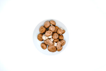 Fresh champignon mushrooms isolated on white. Top view or flat lay.