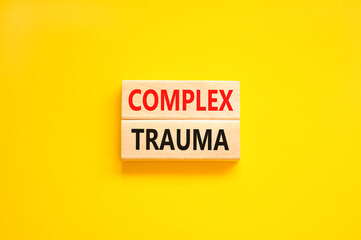 Complex trauma symbol. Concept words Complex trauma on wooden block. Beautiful yellow table yellow...