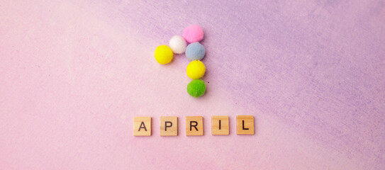 date April 1. Creative concept for April Fools' Day. Festive decor on the color background