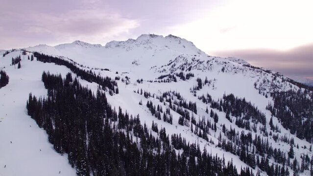 Whistler Mountain lodge and gondola at sunset, aerial drone footage, ski hill, winter mountain, vista. 4K 24FPS