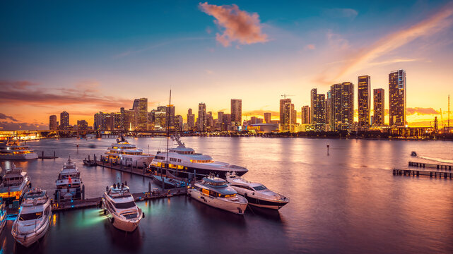 the skyline of miami during sunset with a marina