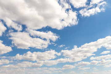 Naklejka premium Natural beautiful abstract scenic azure blue sky with white cumulus clouds background on bright sunny summer day. Nature cloudscape tranquil landscape scene backdrop pattern