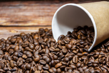 Fototapeta na wymiar Paper coffee cup with coffee beans