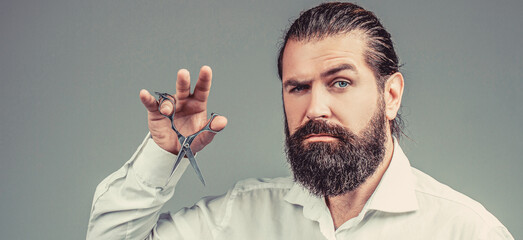 Bearded man isolated on gray background. Mans haircut in barber shop. Barber scissors, barber shop....