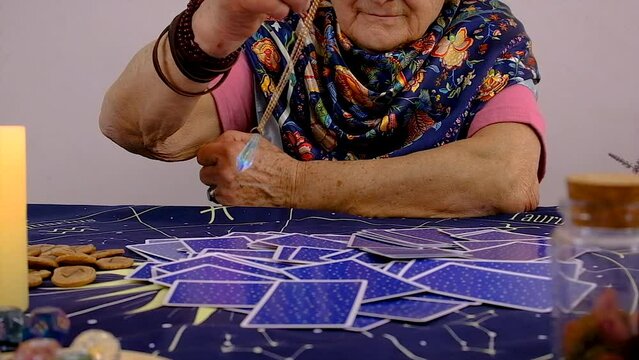 Fortune teller woman reads tarot cards. Selective focus.