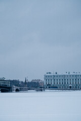 Bridge over the river and embankment in winter in a big city.