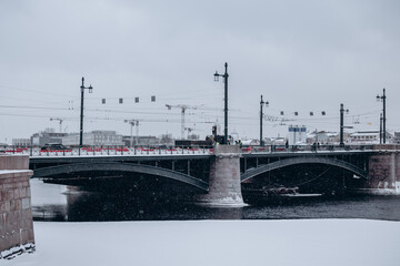 Bridge over the river and embankment in winter in a big city.