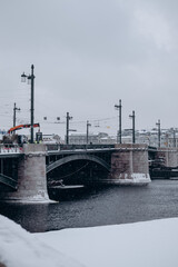 Bridge over the river and embankment in winter in a big city.