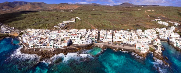 Poster Canary islands travel. Lanzarote scenic places. Charming  Punta Mujeres traditional fishing village. aerial drone view. popular  for natural swim pools. © Freesurf