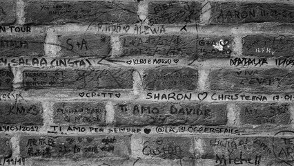 the wall of a brick building has been filled with the names of the authors