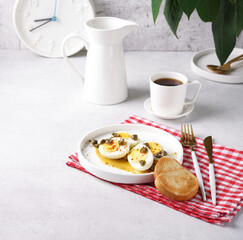Appettizer breakfast with deviled eggs with paprika, mustard and capers and coffee. copy space