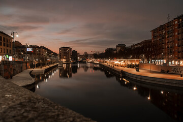 Fototapeta premium sunset at the Naviglio in Milan. The catering businesses begin their umpteenth glamorous evening