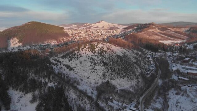 Drone aerial view of winter small provincial russian town from air. Russia Siberia Gorno-Altaisk
