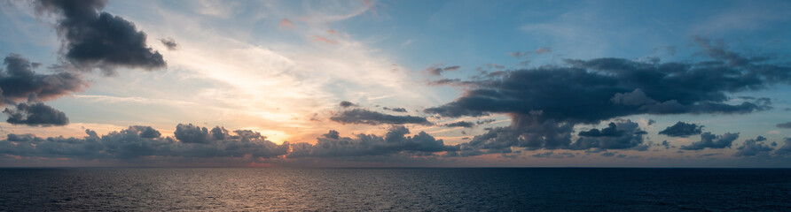 Dramatic Colorful Sunset Sky over Mediterranean Sea. Clouds with Sunrays. Cloudscape Nature Background. Panorama