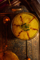 Sholeh Zard, a Persian saffron rice pudding, dessert with cinnamon, pomegranate and pistachio garnish	