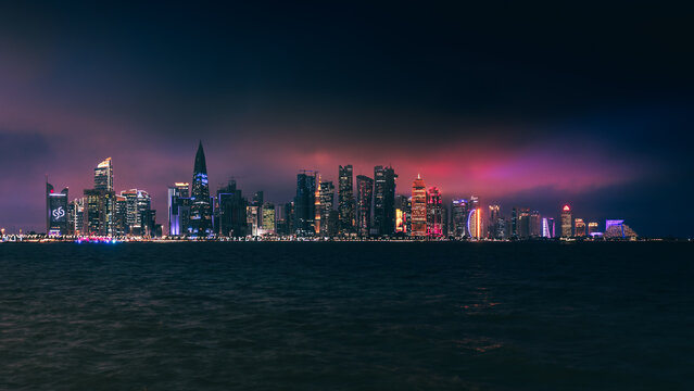 doha skyline at night, skyscrapers standing tall and in line in the concrete jungle