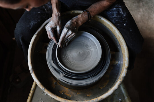 hands of woman working in ceramic and pottery wheel. Small business and entrepreneurship in art in Mexico Latin America