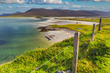 The beautiful sandy beach and clear turquoise sea at Seilebost on the isle of Harris in the Western isles of Scotland - obrazy, fototapety, plakaty