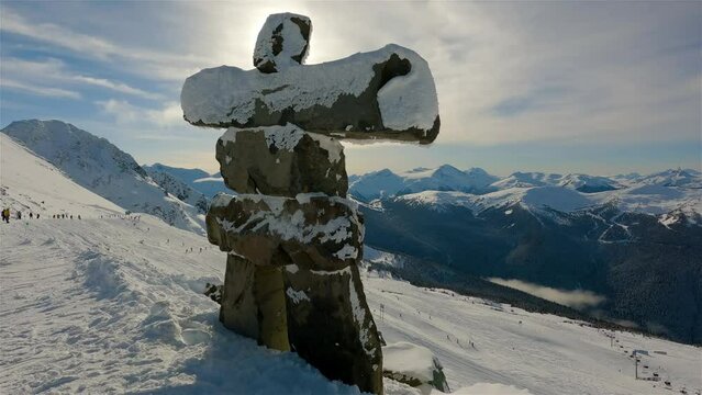 Whistler, British Columbia, Canada. Beautiful View of Statue on top of Blackcomb Mountain with the Canadian Snow Covered Landscape in background during a cloudy and vibrant winter day. Slow Motion