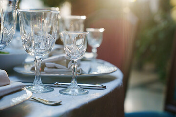 empty wine glasses on the table.table setting for a festive dinner. solar glare.