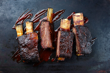 Traditional barbecue burnt chuck short beef ribs marinated with spicy rub and served with a hot...