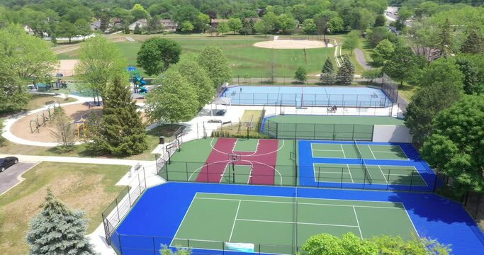 Suburban park with tennis, pickleball and basketball courts and a hockey rink.
