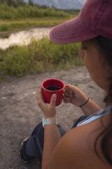 Women drinking coffee during sunrise in grand teton national park in Wyoming