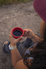 Women drinking coffee during sunrise in grand teton national park in Wyoming