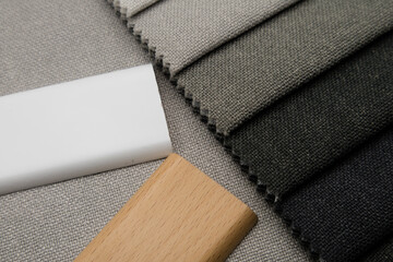 White and natural wood color on fabric swatches background. Selection of materials for the interior.
