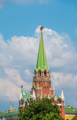 Fototapeta na wymiar Troitskaya tower of Moscow Kremlin on a blue sky background in sunny summer day
