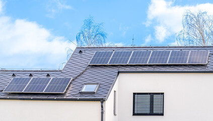 solar panels for the production of electricity from the sun on the roof of a family house
