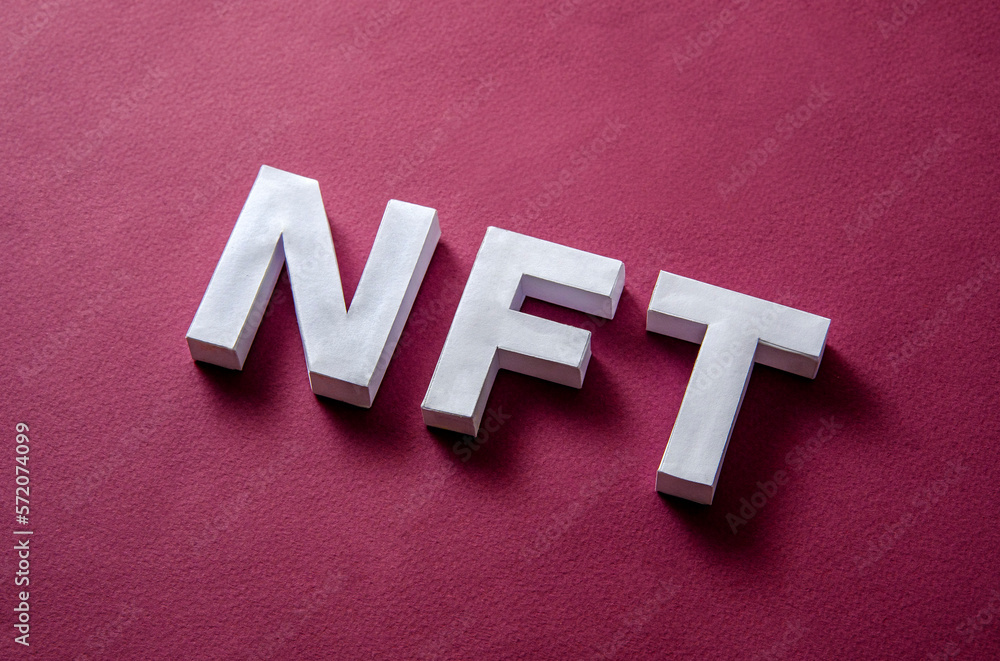 Poster nft text on a red background diagonally as a concept of modern technologies of online payments and c