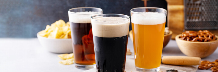 Variety of beer with snacks on the table