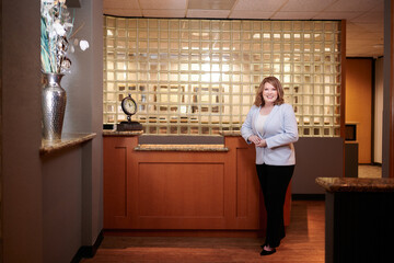 THE WOODLANDS, TEXAS - FEBRUARY 2023: a dental surgeon is posing for environmental business portraits in her practice. She specializes in Laser Dentistry, DURAthin, Lumineer veneers, dental implants.
