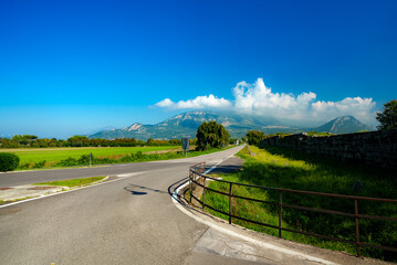 Road and view of Mount Polveracchio and Monte Soprano in Italy.