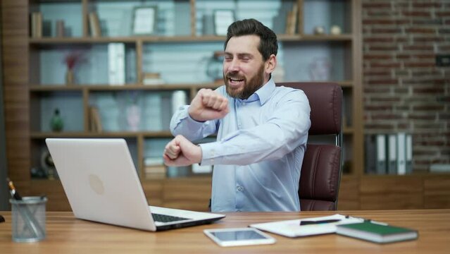 Overjoyed business man investor extremely happy after read email message on laptop at modern workplace Excited entrepreneur look at screen and dancing while received great news on computer indoors