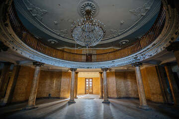 Entrance round hall with chandelier at the abandoned palace