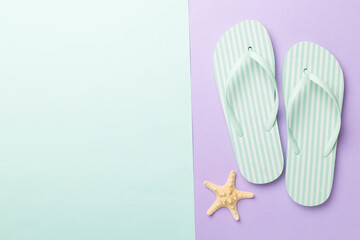 Striped flip flops on color background, top view