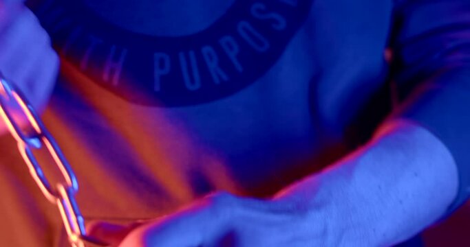 Demonstration of a metal chain in hands. Police flashing lights. Length defense against attack.