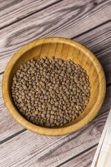 A bamboo bowl filled with dried lentils