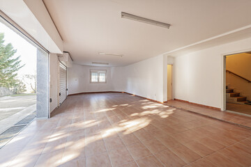 Large empty garage of a detached house with two white metal extendable doors