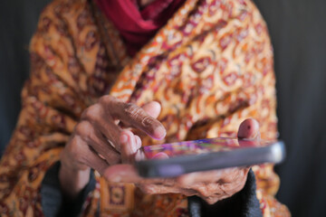  senior women hand using smart phone close up 