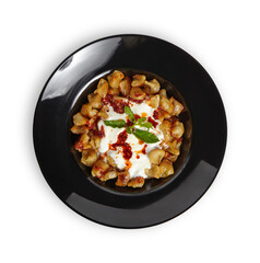 Turkish Dumplings (Mantı) in black plate isolated white background.